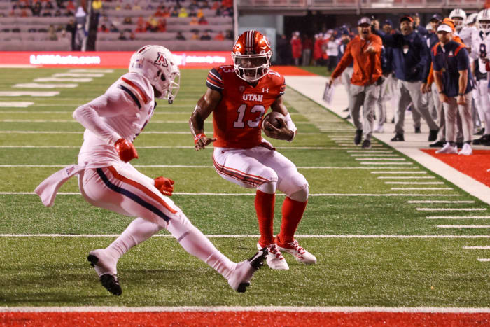 Utah Utes quarterback Nate Johnson (13) runs the ball for a touchdown against Arizona Wildcats cornerback Ephesians Prysock (7) in the second quarter at Rice-Eccles Stadium.